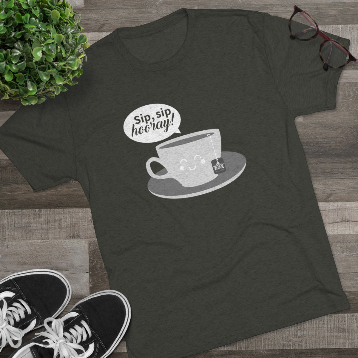 Dark green graphic tee featuring a cute tea cup with the text "Sip, sip, hooray!" and a tea bag.