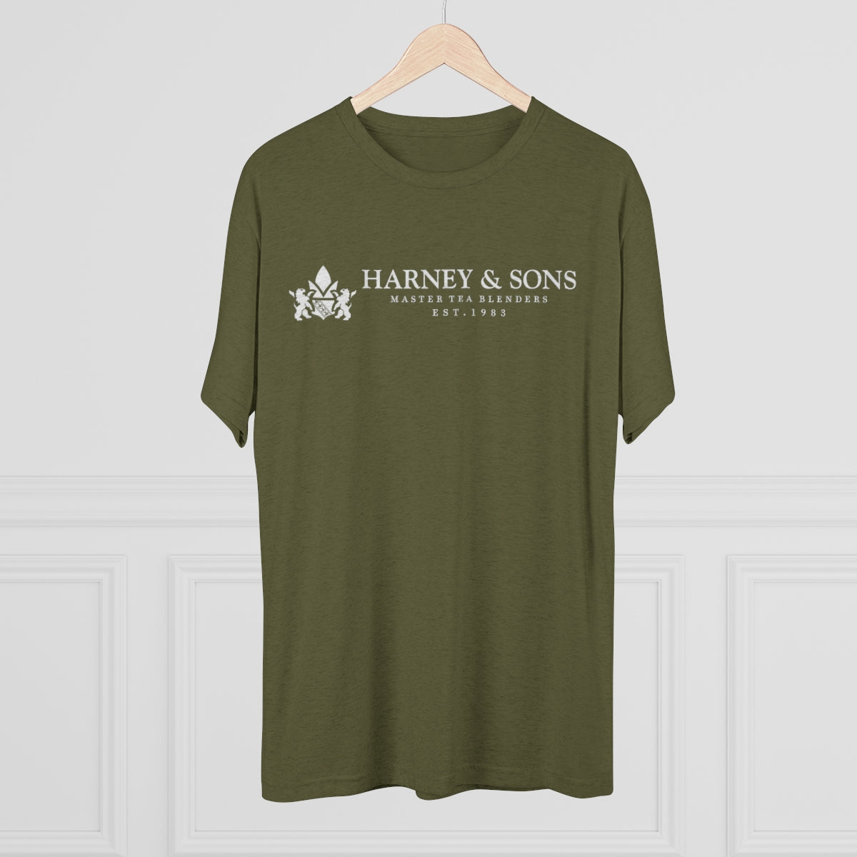 Olive green graphic tee featuring "Harney & Sons Master Tea Blenders Est. 1983" logo. Perfect for tea enthusiasts.