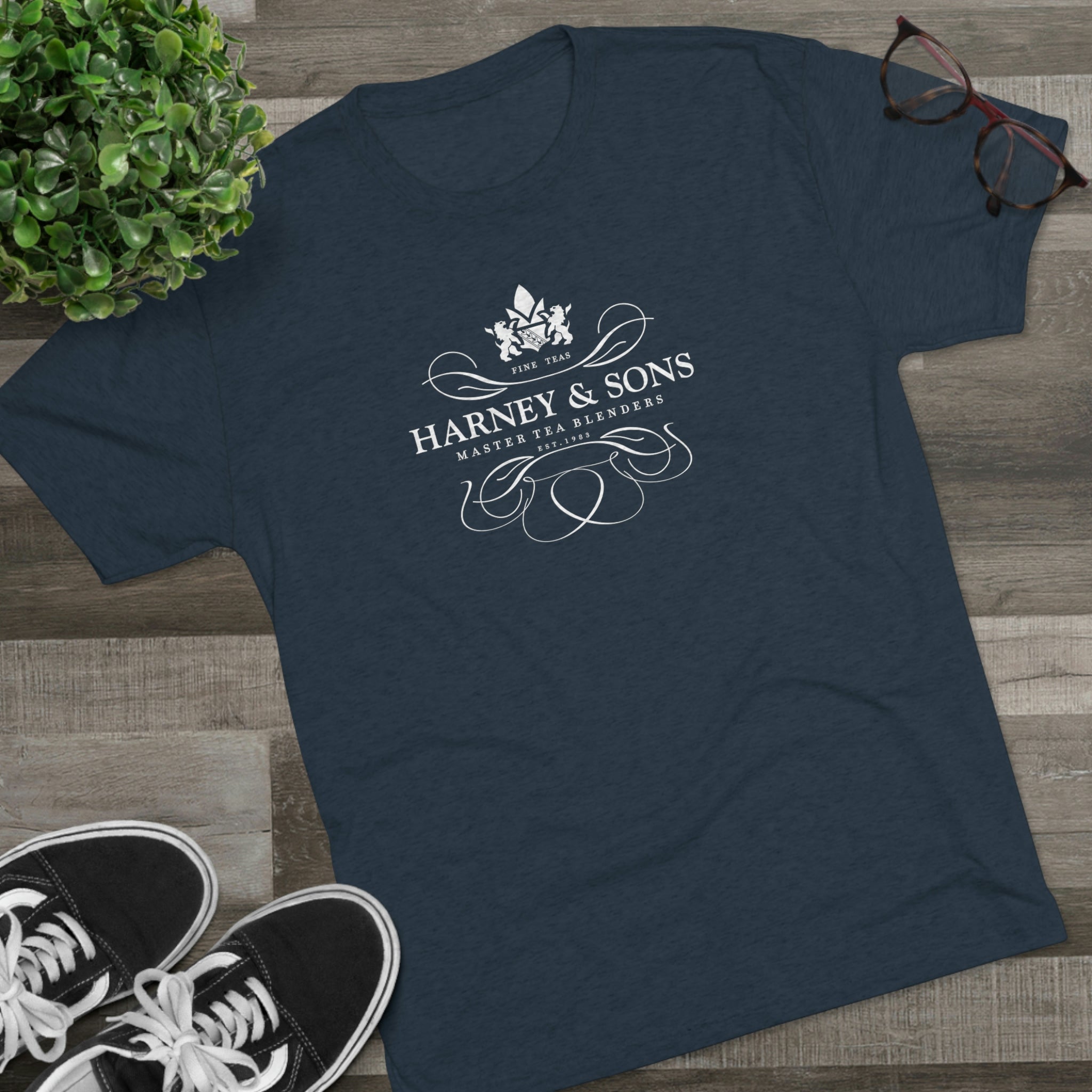 Navy graphic tee featuring the Harney & Sons logo, styled with elegant script and floral design. Perfect for tea lovers.