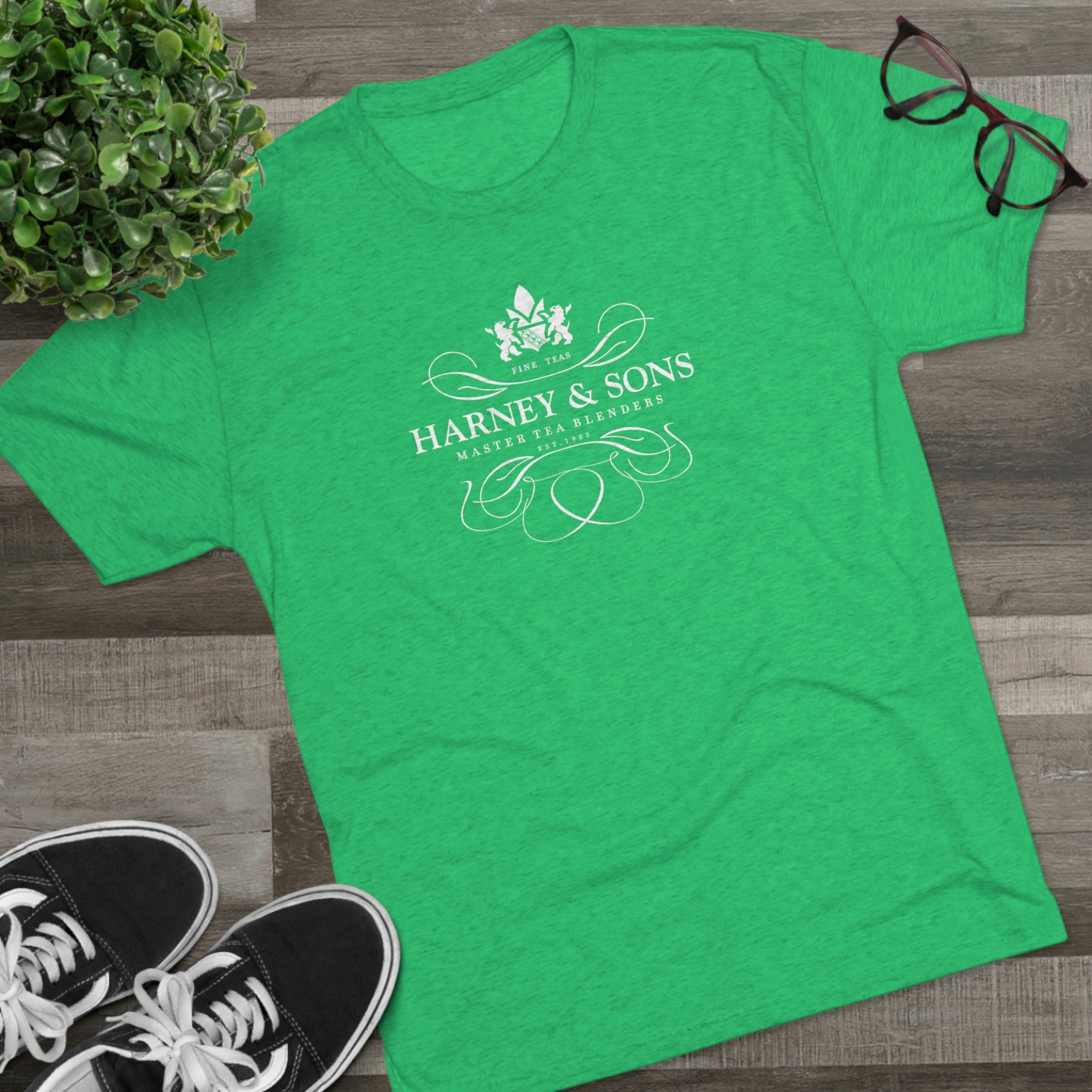 Green graphic tee featuring the Harney & Sons logo, styled with elegant typography and decorative elements.