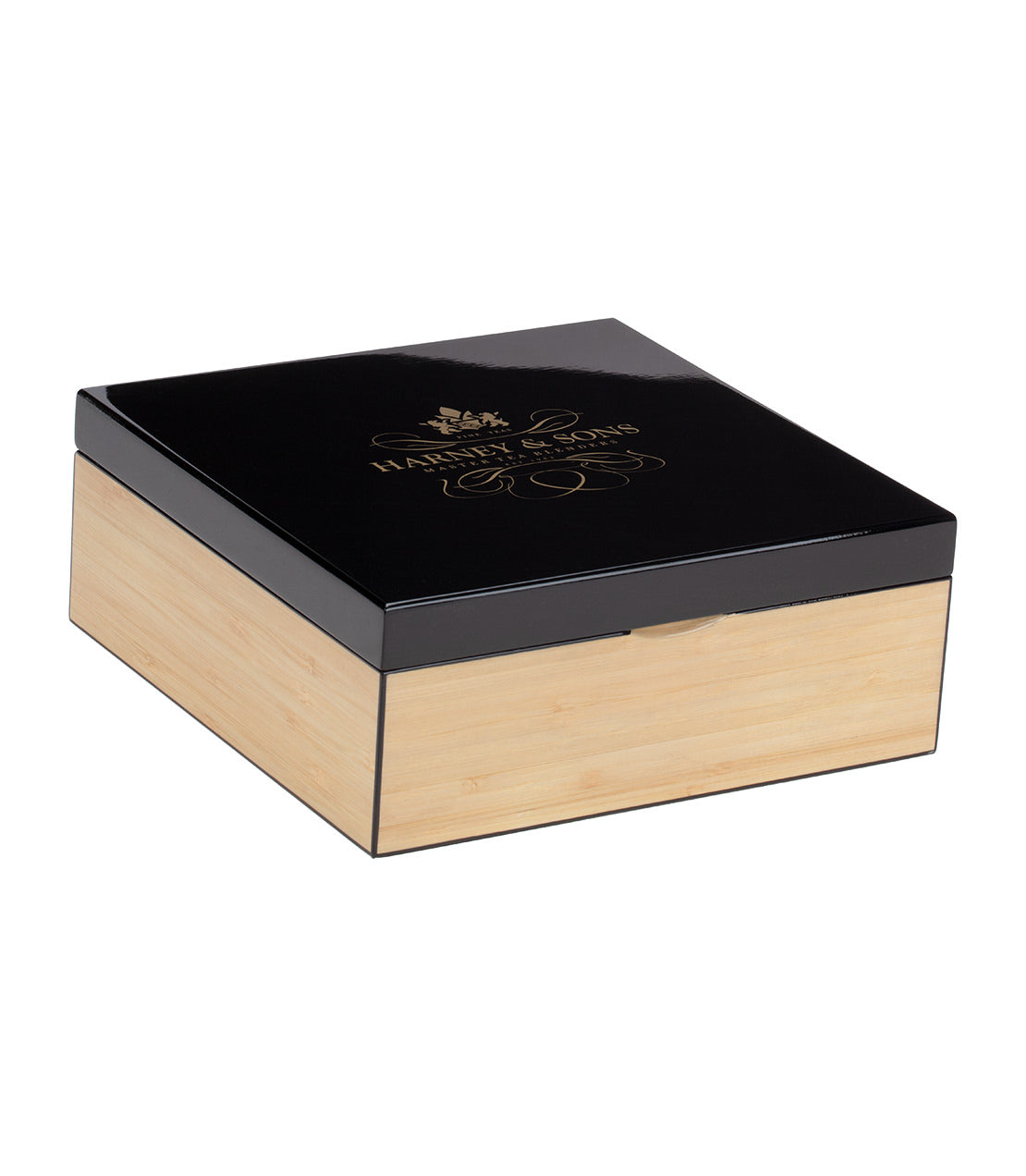 Elegant heirloom tea chest with a sleek black lid and bamboo base, containing nine assorted teabags.