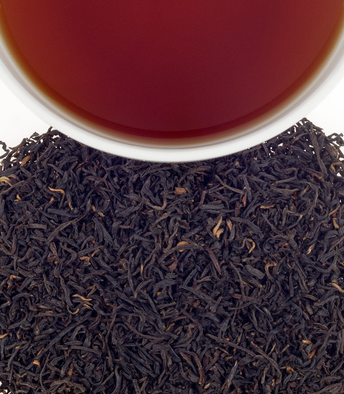 Rich amber tea in a white cup above a mound of loose black tea leaves, showcasing Hao Ya 'B' variety.