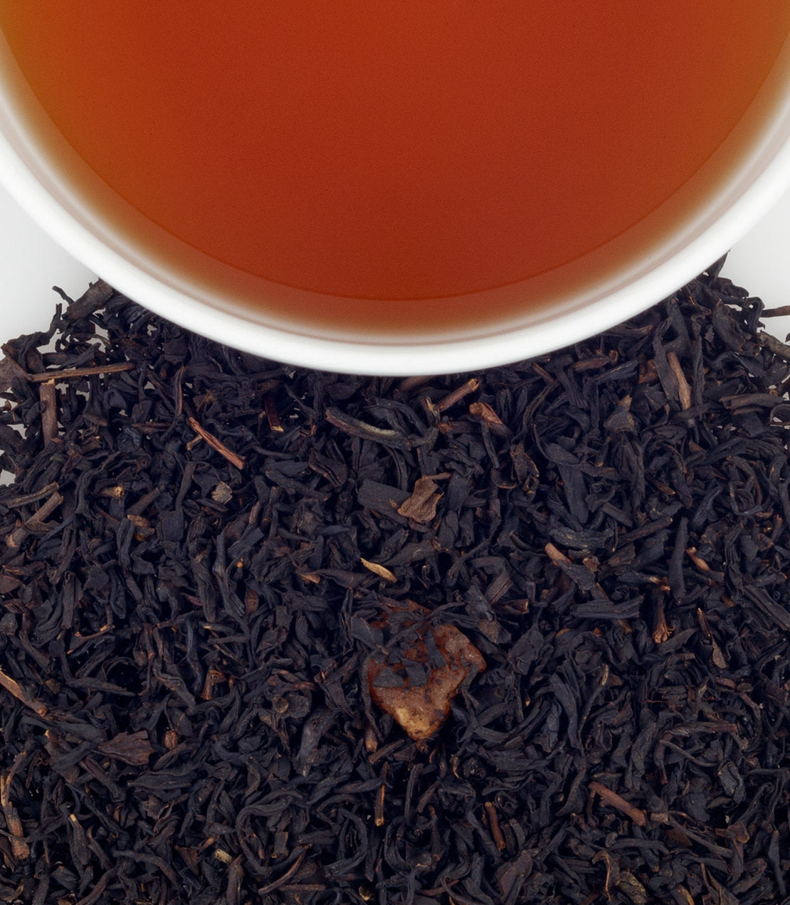 Mango Black tea sachets in a bag of 50, with brewed tea and loose tea leaves displayed.
