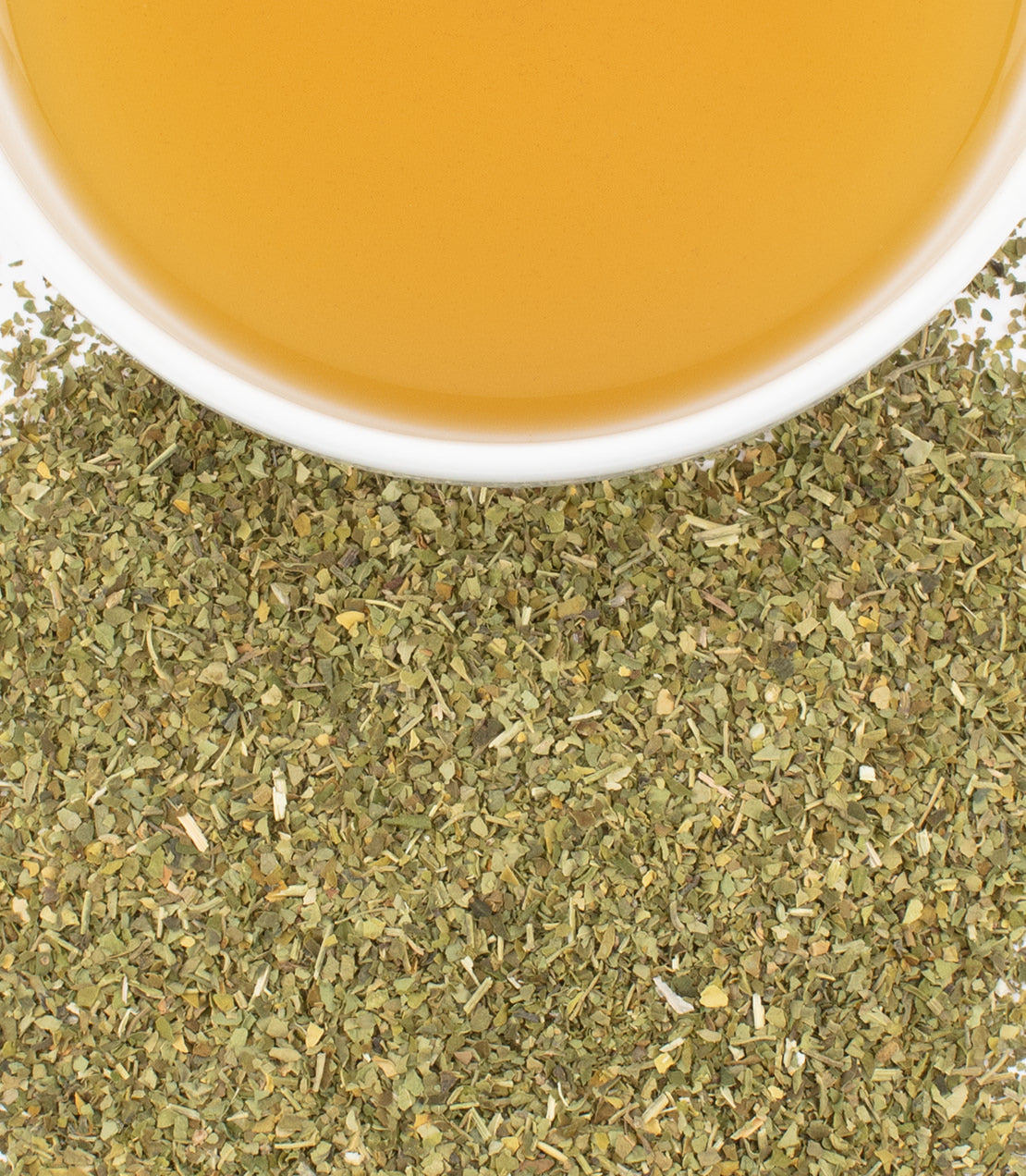 Dried moringa leaf powder with a cup of moringa tea, showcasing its vibrant color and texture.