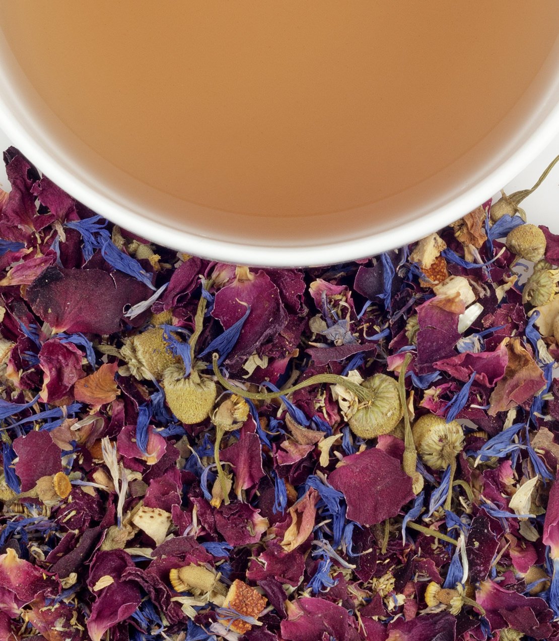 A close-up of dried flower tea blend with a cup of brewed tea, perfect for Mother's Day gifting.