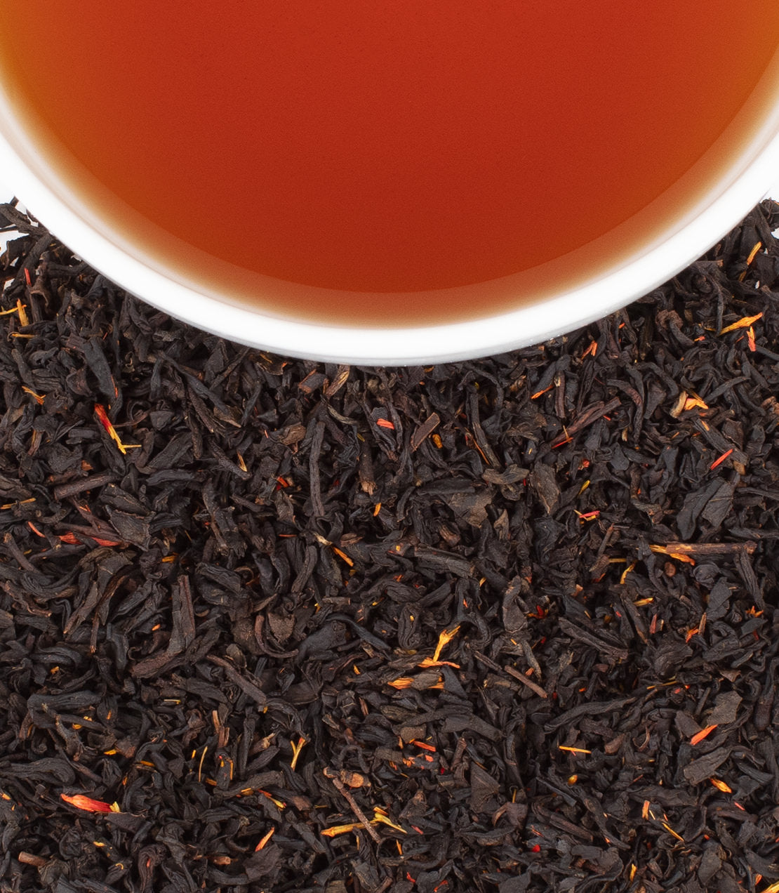 New England Breakfast tea sachets, featuring rich black tea leaves and a cup of brewed tea.