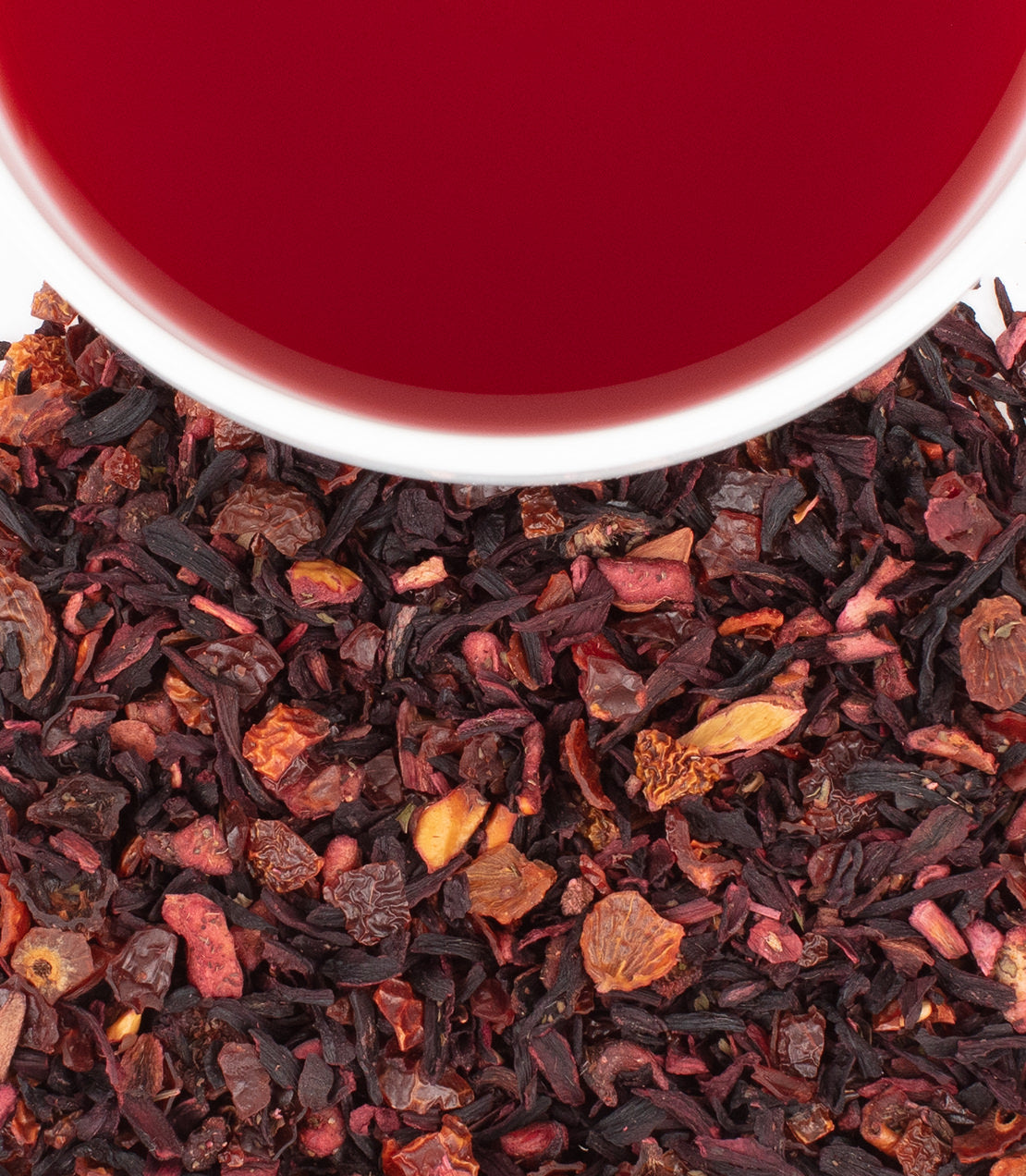 Raspberry Mojito tea blend featuring dried fruits and vibrant red liquid in a white cup.