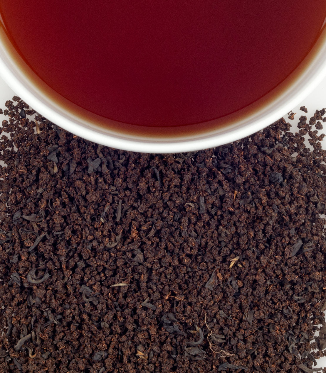 A close-up of Scottish Morn tea leaves with a cup of brewed tea, showcasing rich color and texture.