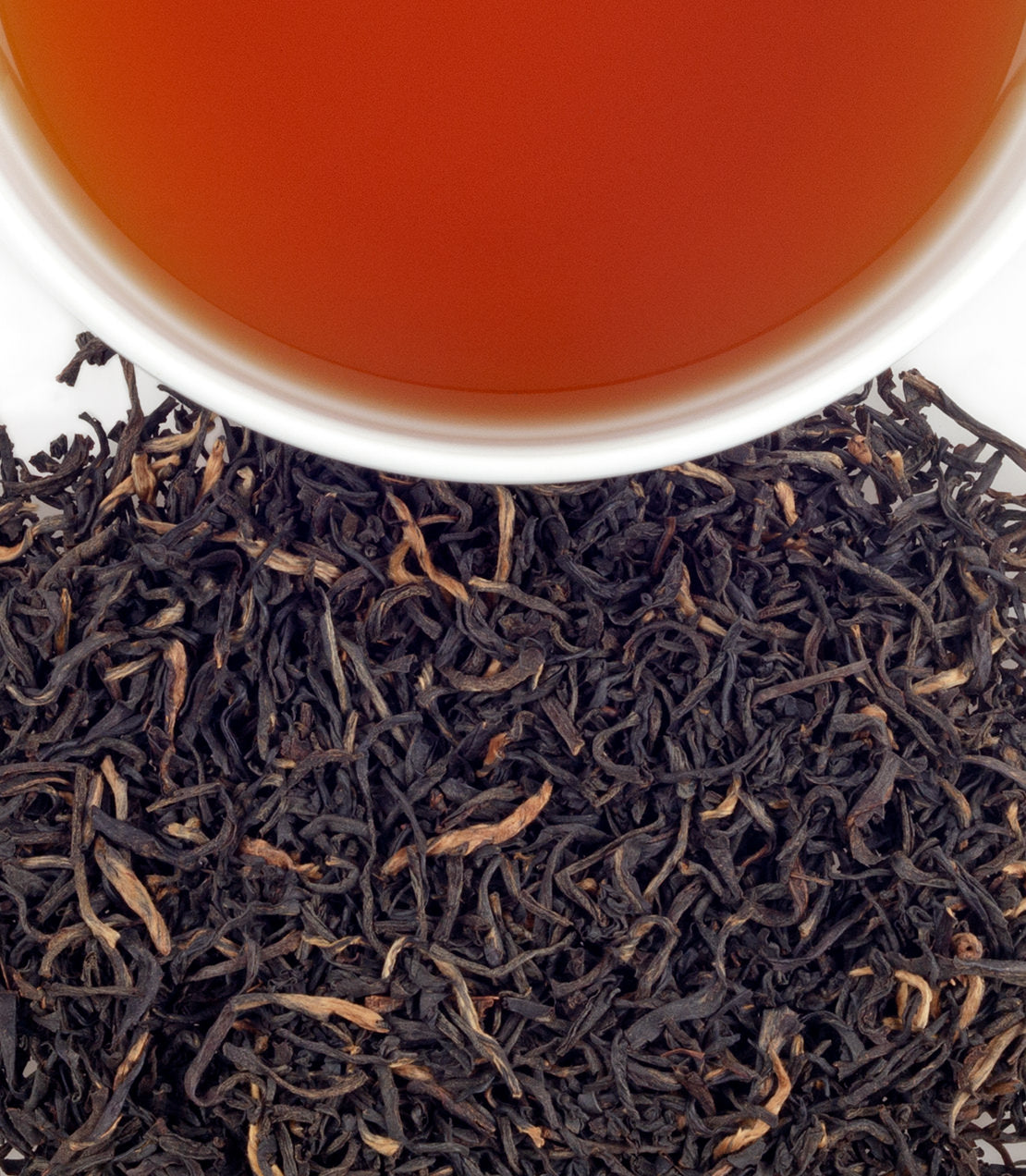 Supreme Breakfast tea sachets in a bag of 50, featuring loose black tea leaves and brewed tea in a cup.