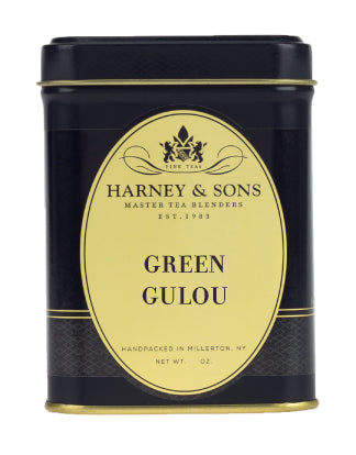 Black tin canister of Harney & Sons Green Gulou tea, featuring a gold label with brand name and weight.