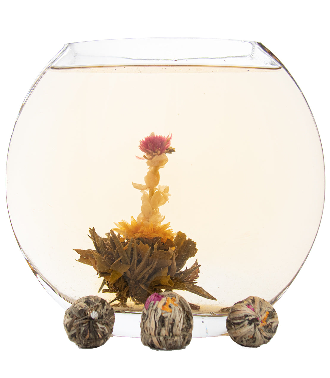 Seven Fairy blooming tea in a glass teapot, featuring vibrant flowers and tea balls for a colorful infusion.