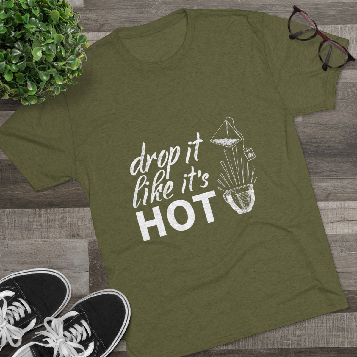 Olive green graphic tee featuring the phrase "drop it like it's HOT" with a coffee brewing illustration.