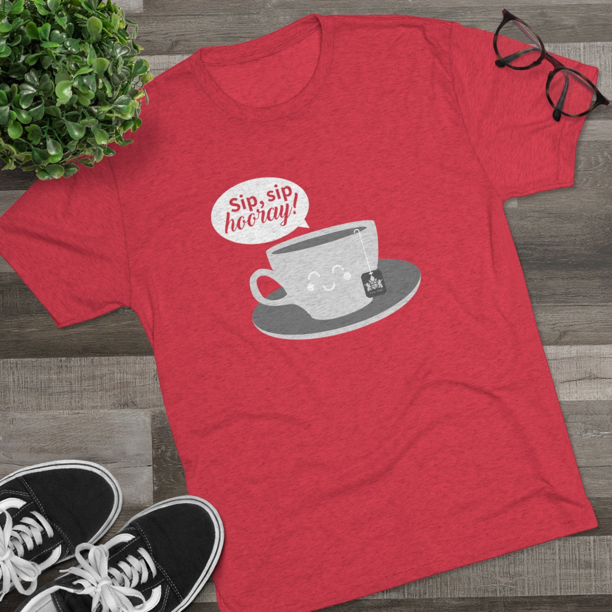Red graphic tee featuring a cute coffee cup design with the text "Sip, sip, hooray!" and a tea bag. Perfect for coffee lovers.