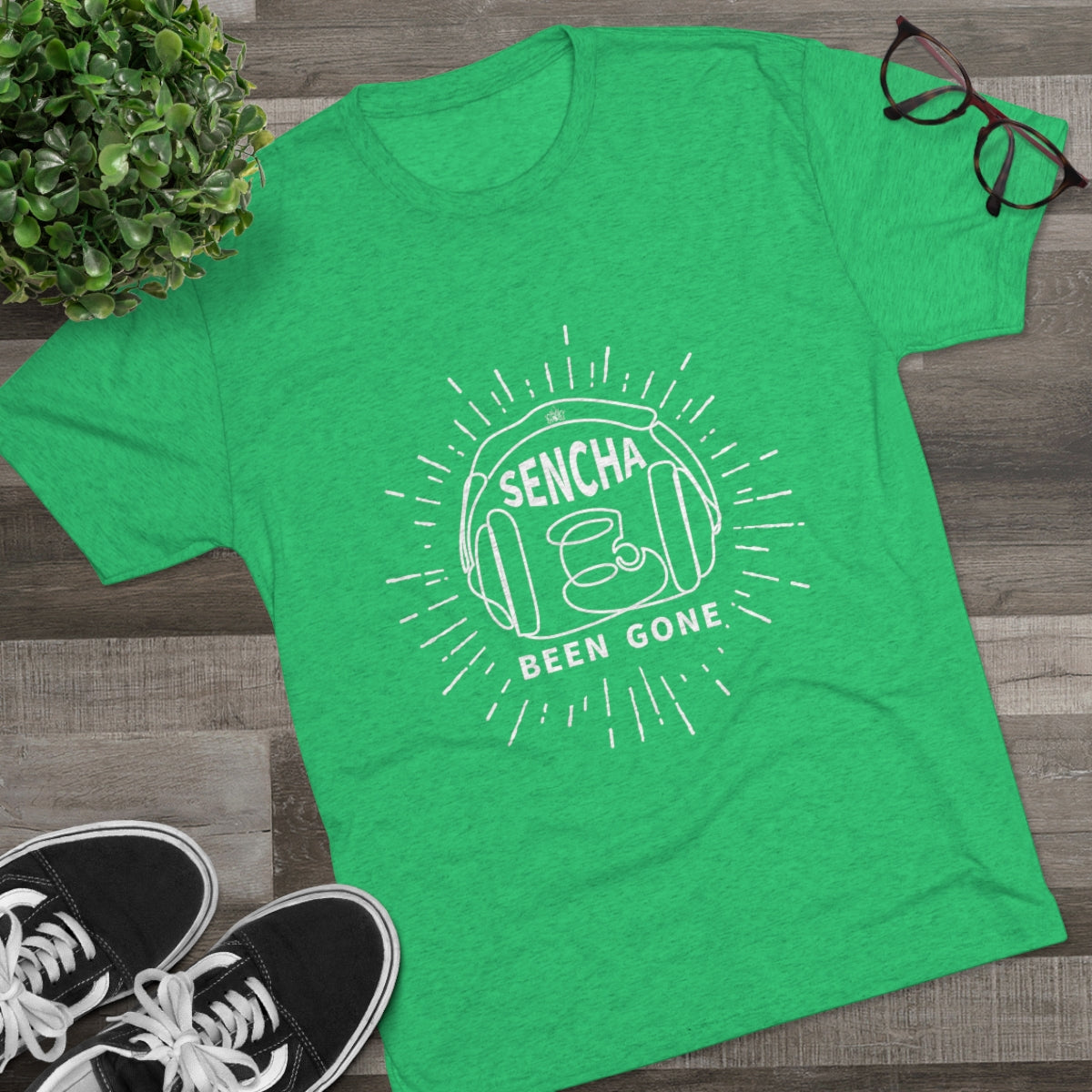 Bright green graphic tee featuring "Sencha Been Gone" design with a teacup and sunburst elements. Perfect for tea lovers.