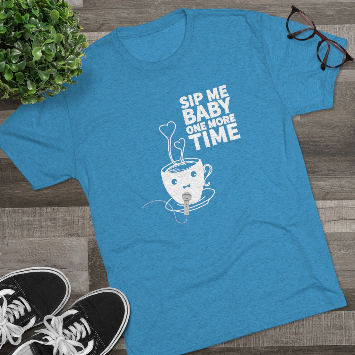 Blue graphic tee featuring a playful coffee cup design with the text "Sip Me Baby One More Time.