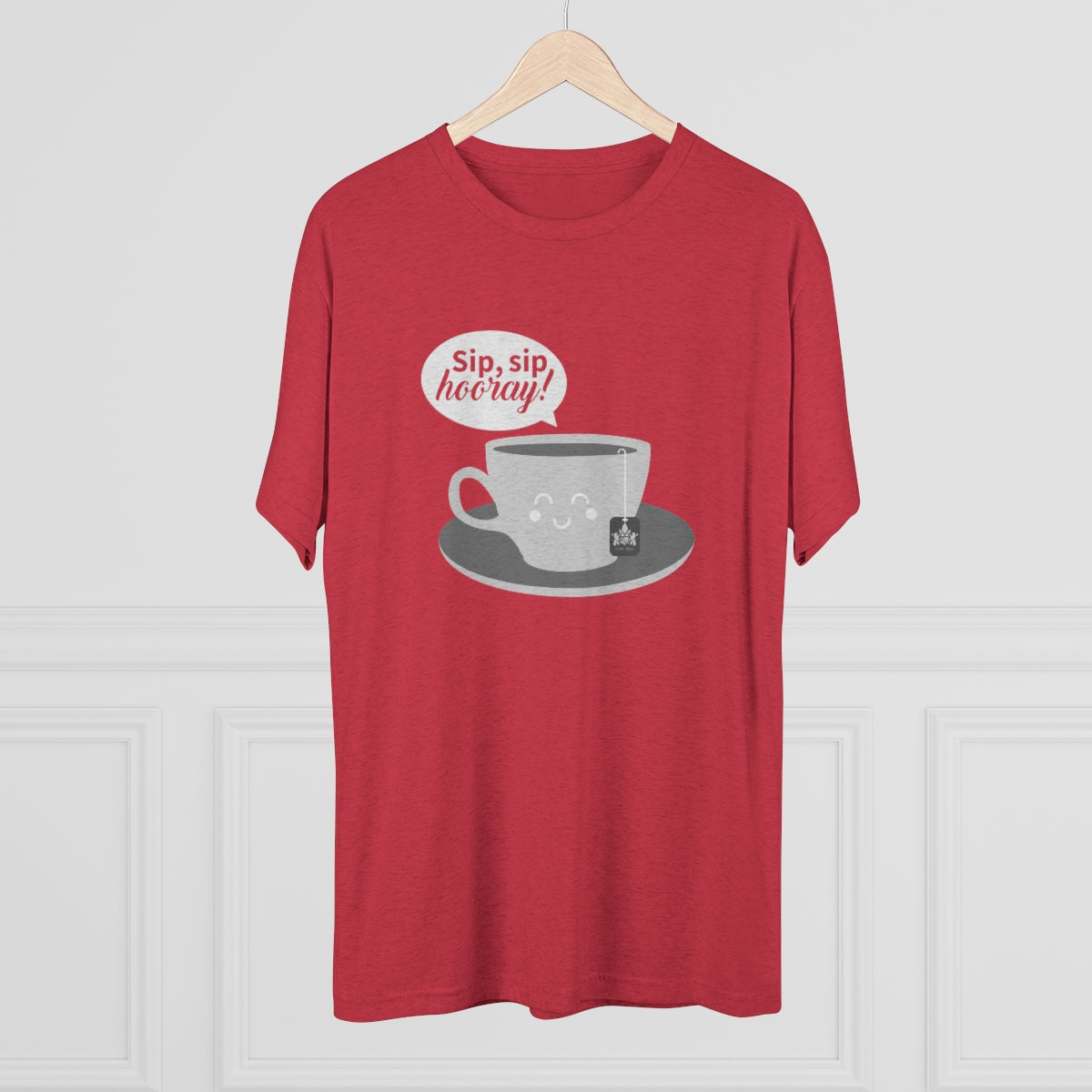 Red graphic tee featuring a smiling coffee cup and the text "Sip, sip hooray!" on a gray plate. Perfect for coffee lovers.