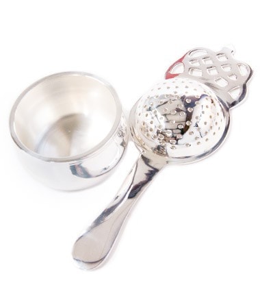 Silver-plated tea strainer with a long handle and decorative design, ideal for brewing loose leaf tea.