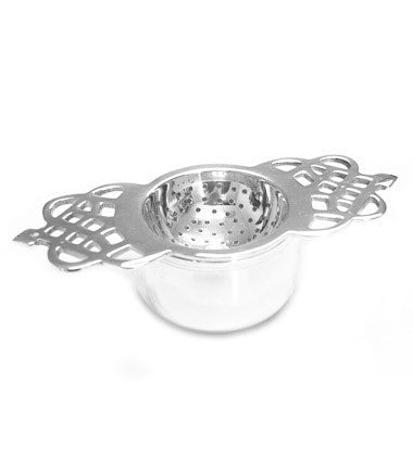 Silver-plated tea strainer with a short handle and intricate design, perfect for brewing loose leaf tea.