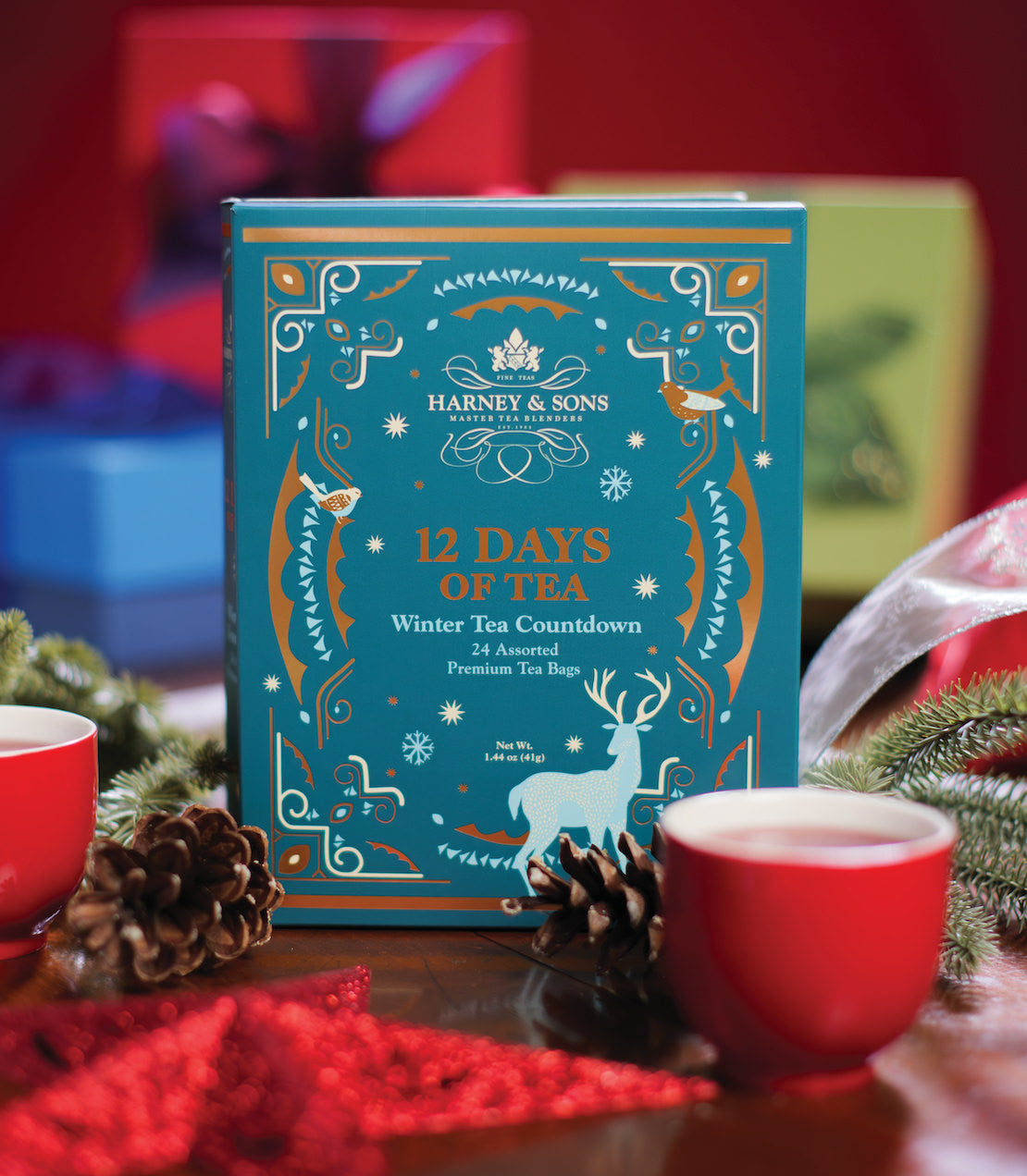 "Harney & Sons 12 Days of Tea Winter Countdown box with 24 assorted premium tea bags, festive decor in background.