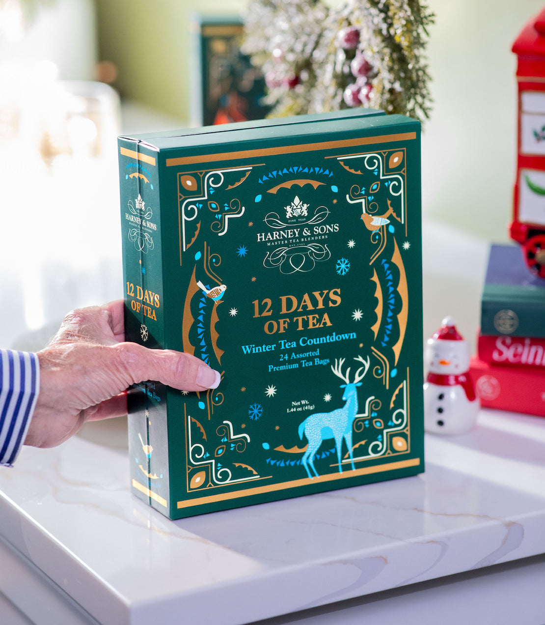 Harney & Sons 12 Days of Tea on a decorative surface with a festive background.