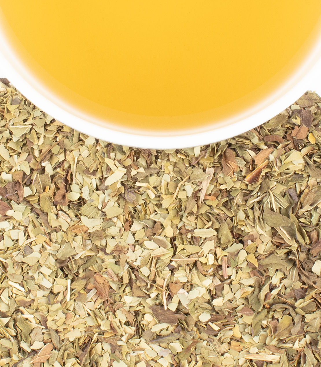 Yerba mate tea with mint leaves, showcasing a vibrant yellow brew and dried herbal blend.