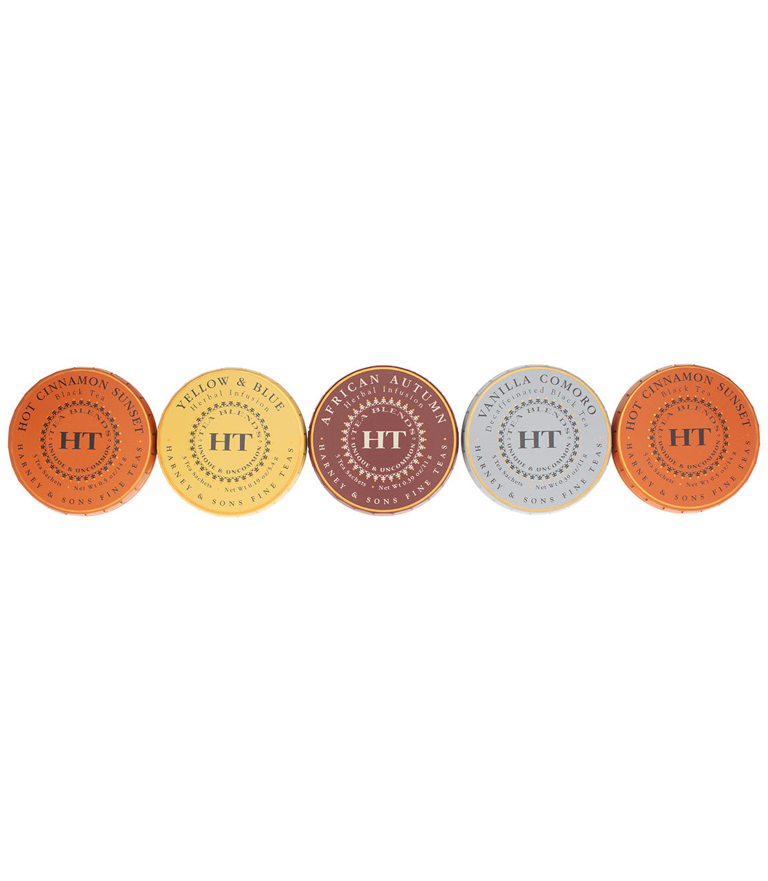 Five round tins of HT Collection teas, including Hot Cinnamon Spice, Yellow & Blue, African Autumn, and Vanilla Comoro.