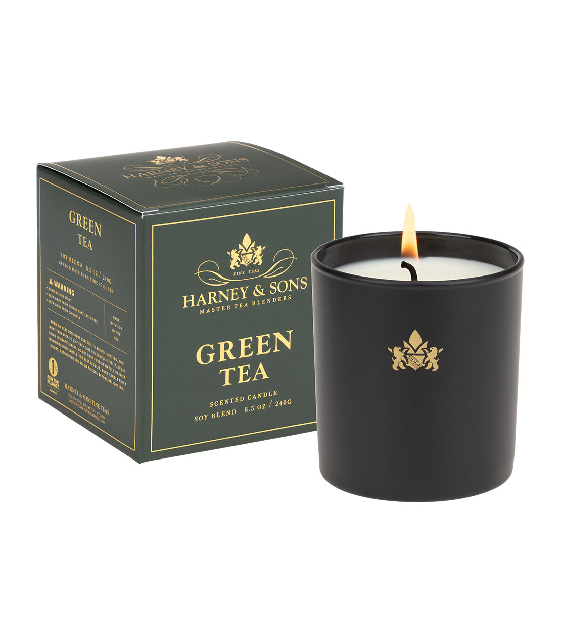 Harney & Sons green tea scented candle in a black jar, with a matching box, showcasing a lit wick.