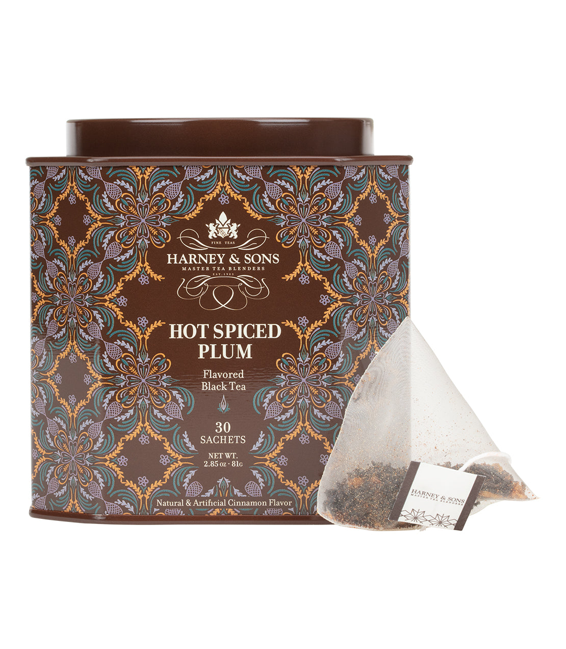 A decorative tin of Harney & Sons Hot Spiced Plum flavored black tea with a single sachet beside it.