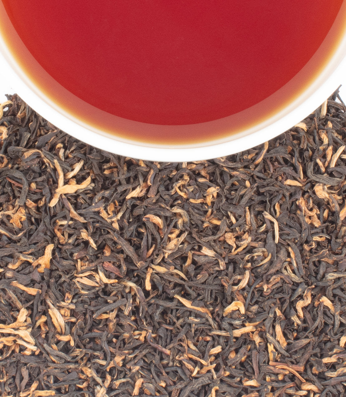 Harney & Sons Fine Teas- Khongea Full Assam- Overhead shot featuring cup of tea and loose tea leaves