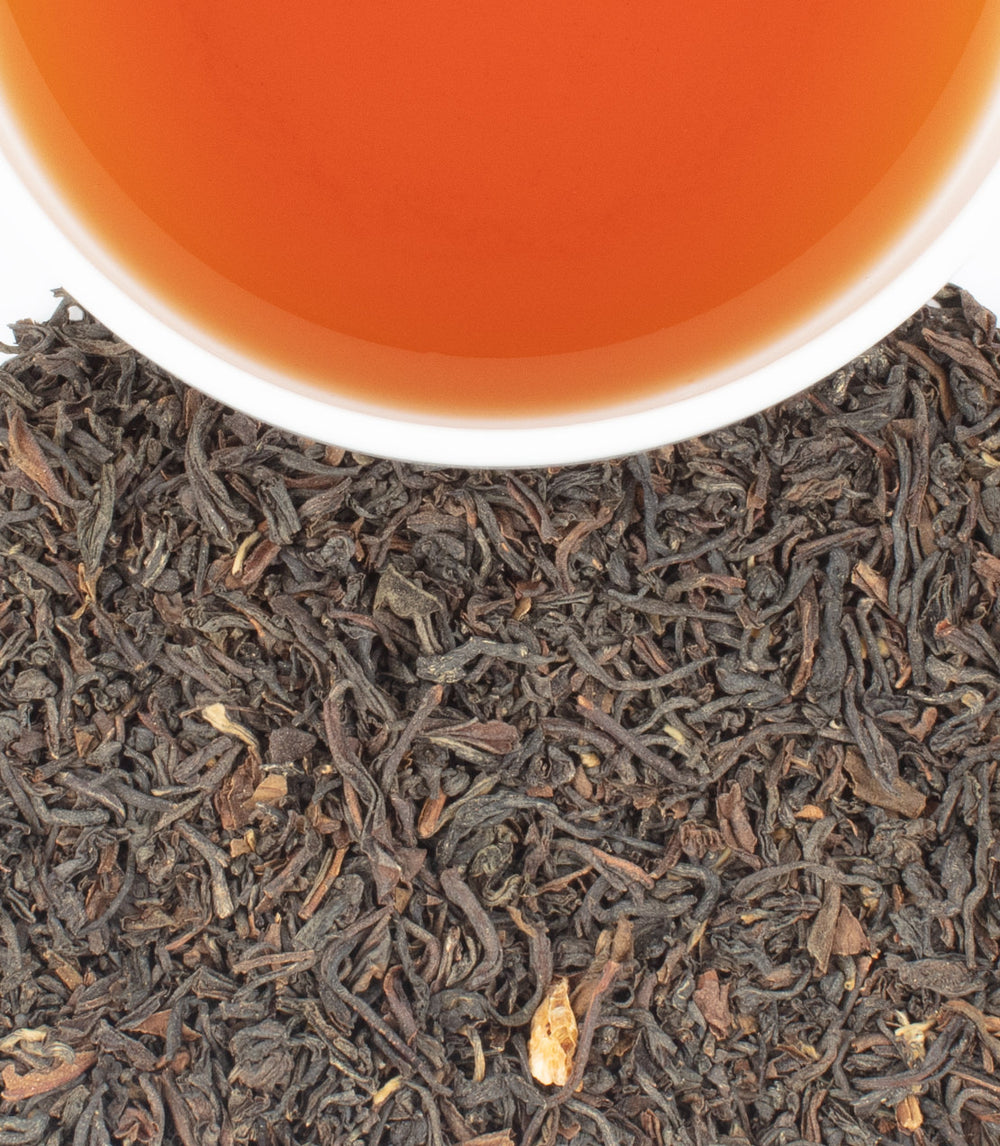 Harney & Sons Fine Teas- Maruichi Select- Overhead shot of brown/orange cup of tea with tea leaves below