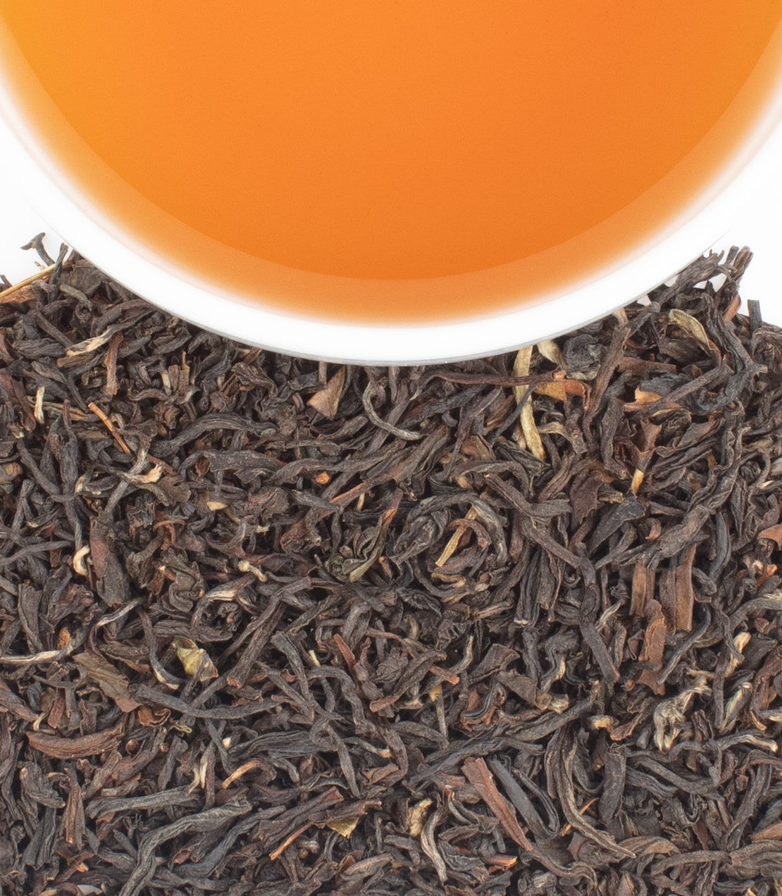 Harney & Sons Fine Teas- Namring 2nd Flush Darjeeling -   - Overhead shot of loose leaves with brewed cup above