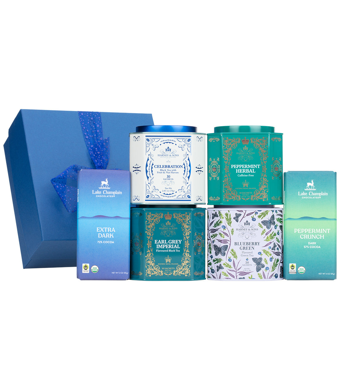 A tea gift set from Harney & Sons featuring a large blue presentation box with a blue ribbon, four decorative metal tea tins in blue, teal, and white, and two slim blue chocolate bar wrappers, all arranged on a white background.