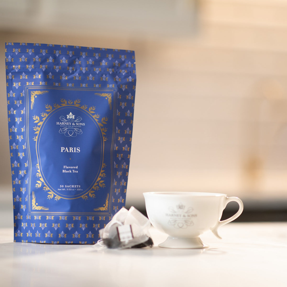 Paris Bag of 50 Sachets on a kitchen counter with a tea sachet and a white teacup