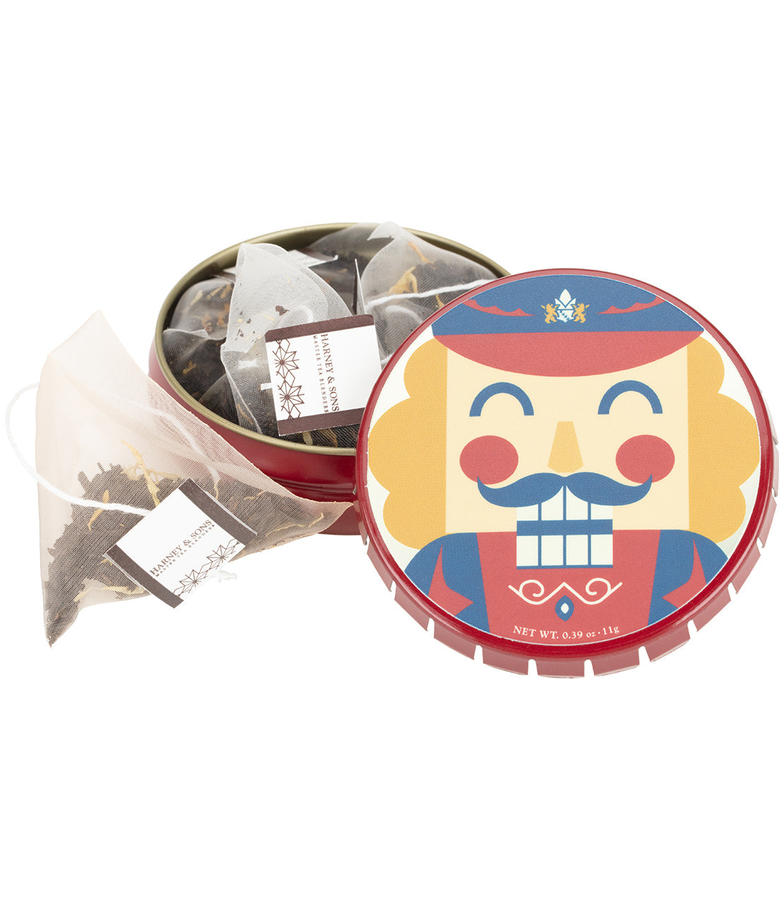 A round red tagalong tin of tea with the lid off, showing several sachets inside and one sachet in front. The lid features a colorful nutcracker illustration.