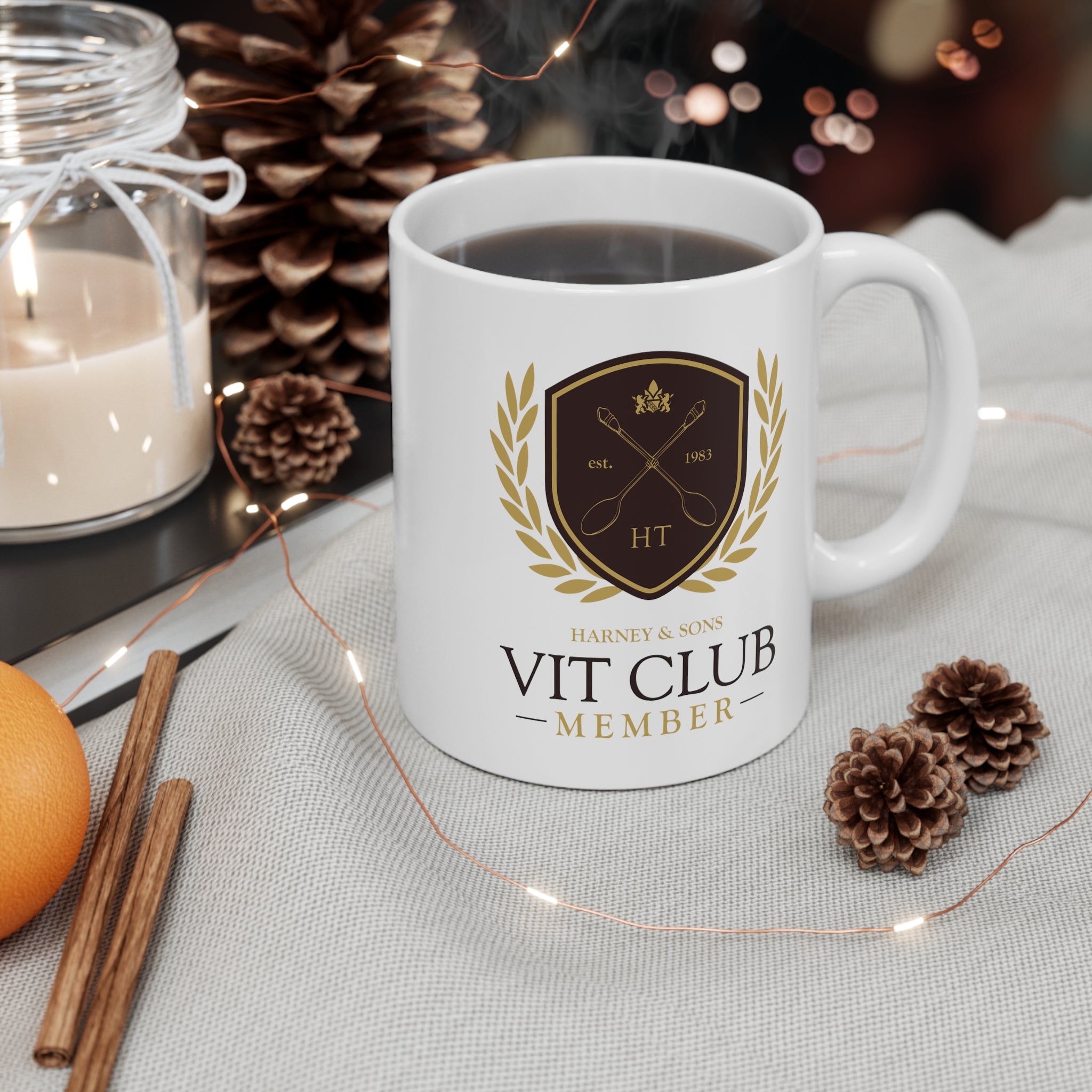White 11 oz. VIT Club mug featuring a logo with "Harney & Sons" and "Member" text, surrounded by pinecones and a candle.