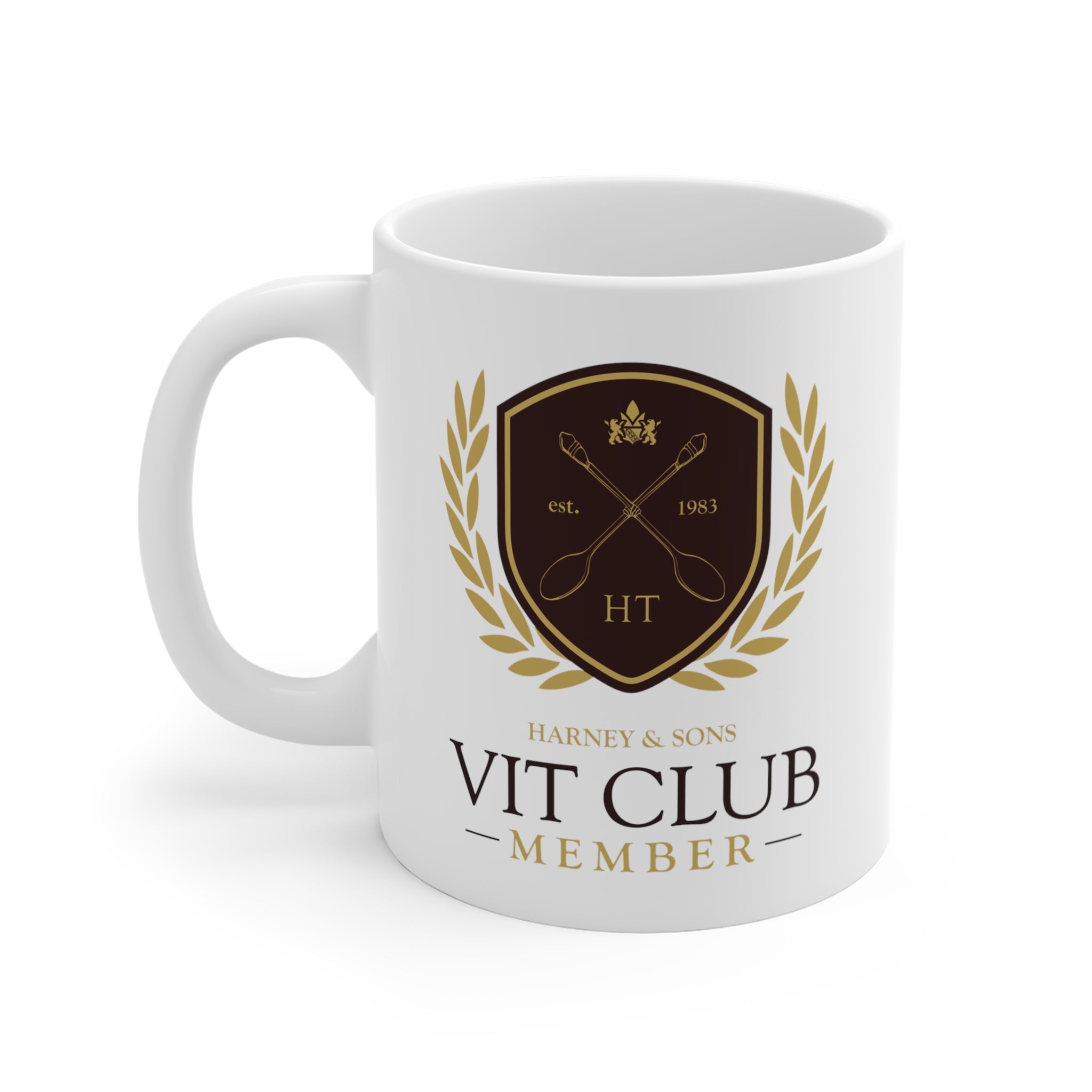 White 11 oz. mug featuring the VIT Club logo with a gold shield, laurel wreath, and "Harney & Sons" text.