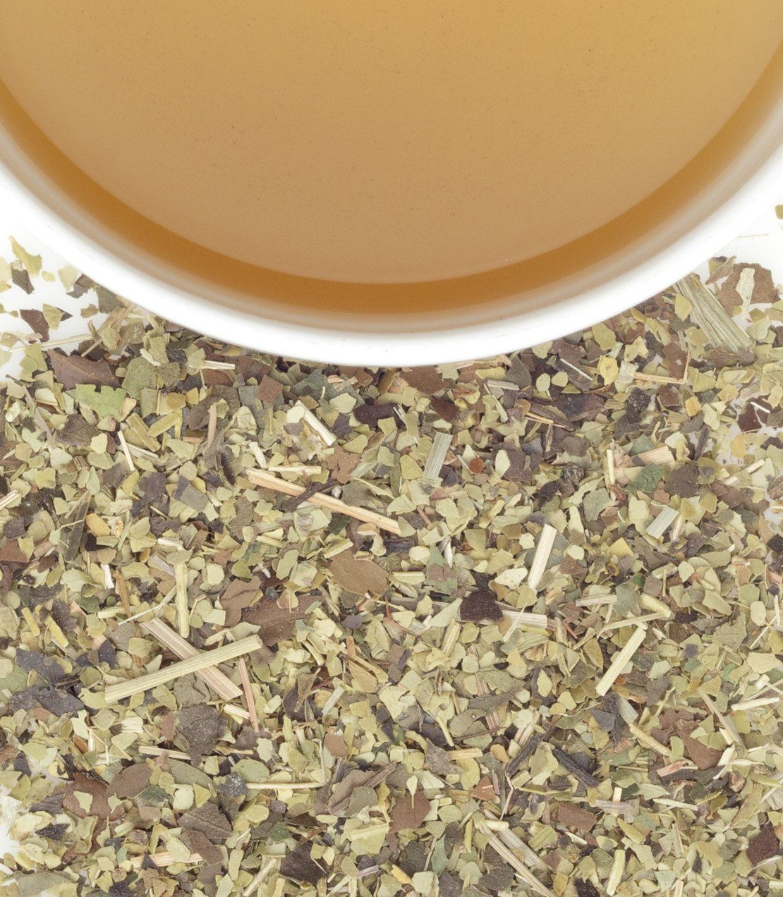 "American Buzz herbal tea sachets with brewed tea in a cup and loose herbs scattered below.