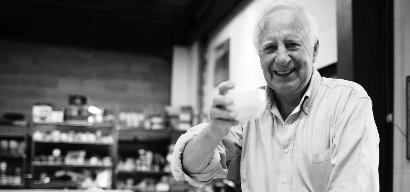 John Harney holding a tasting cup in the Harney & Sons Headquarter's tasting room.