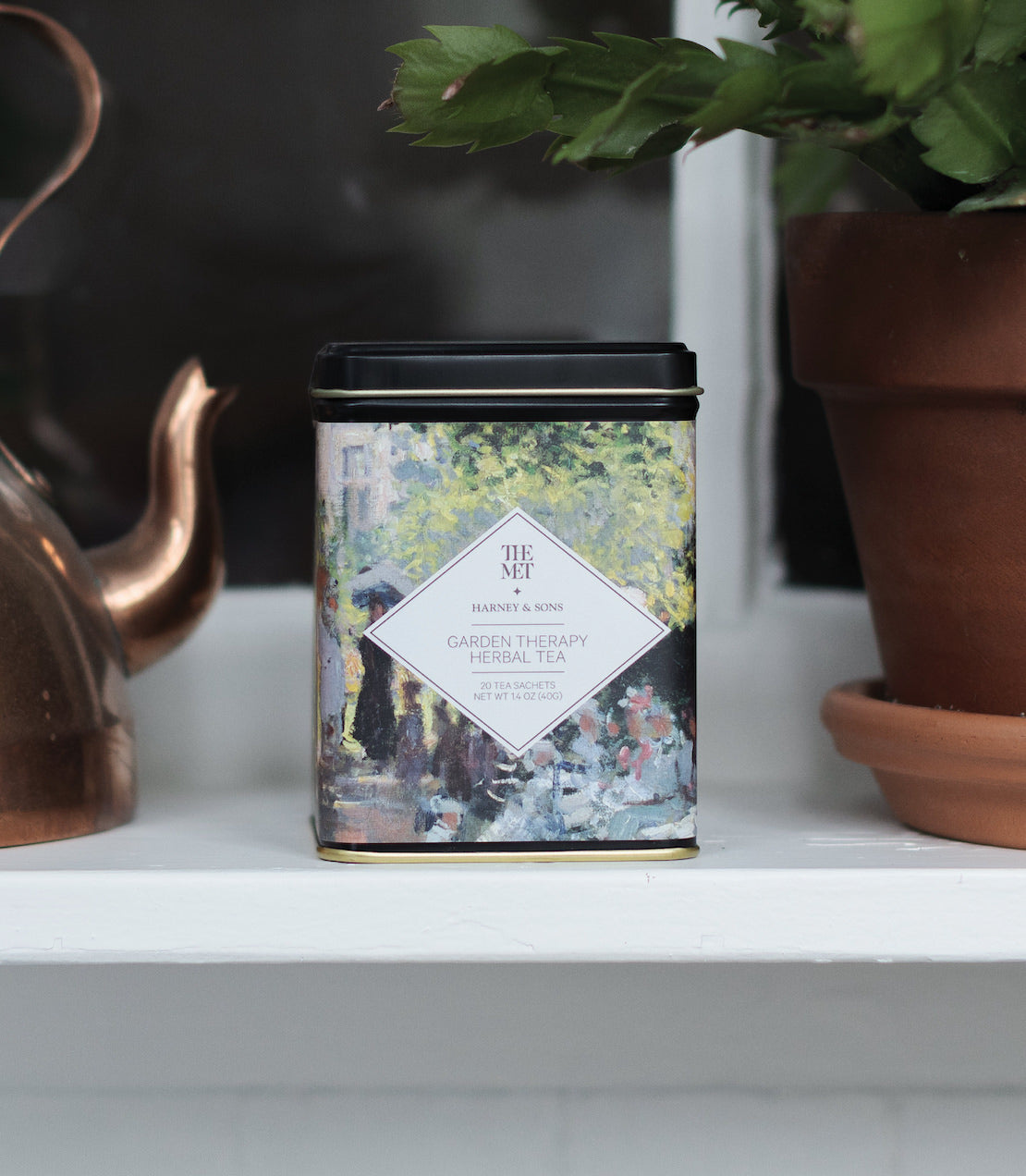 Garden Therapy Herbal Tea tin featuring a floral design, containing 20 sachets for a soothing tea experience.