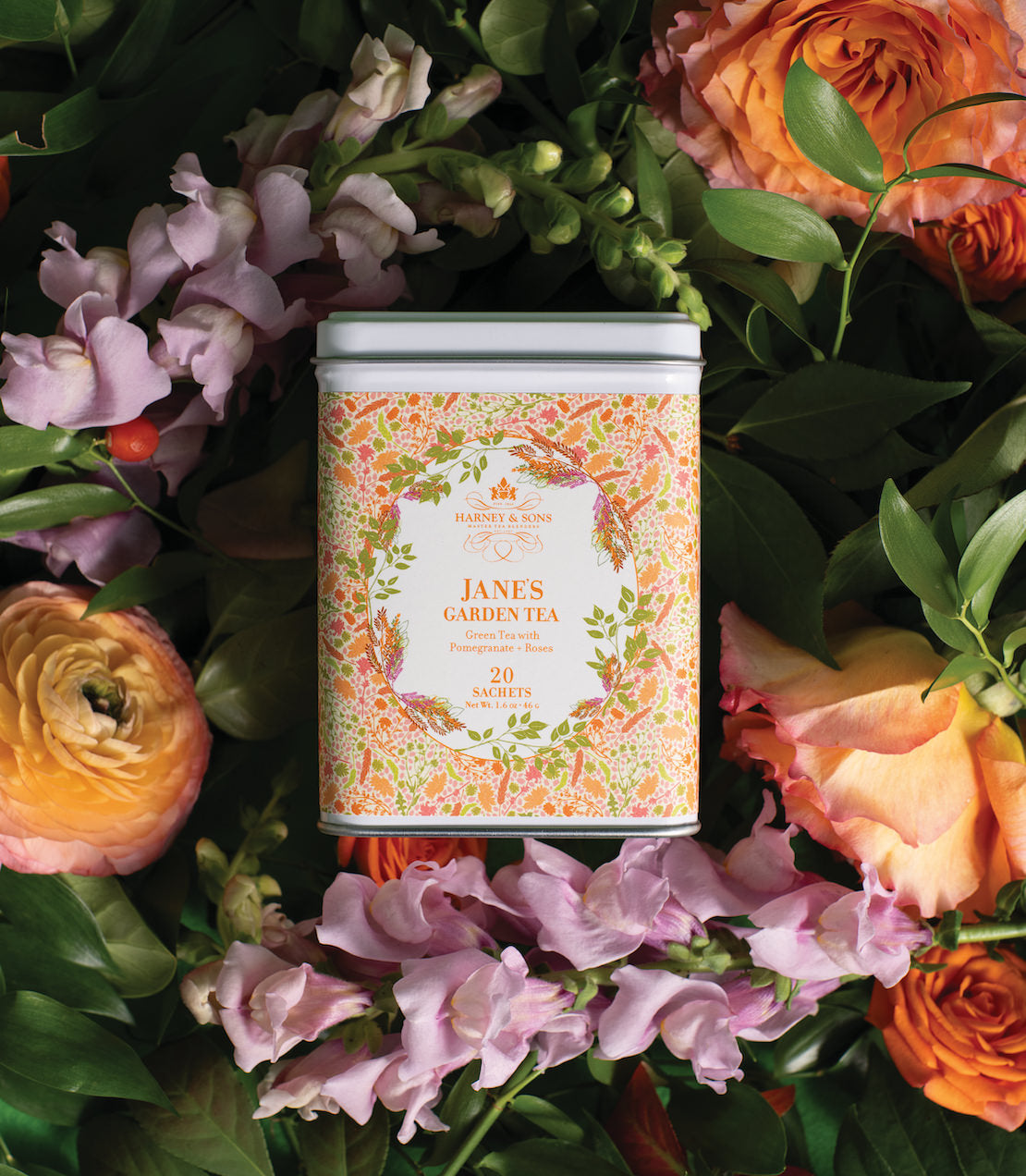 Jane's Garden Tea tin with 20 sachets, surrounded by colorful flowers and greenery.