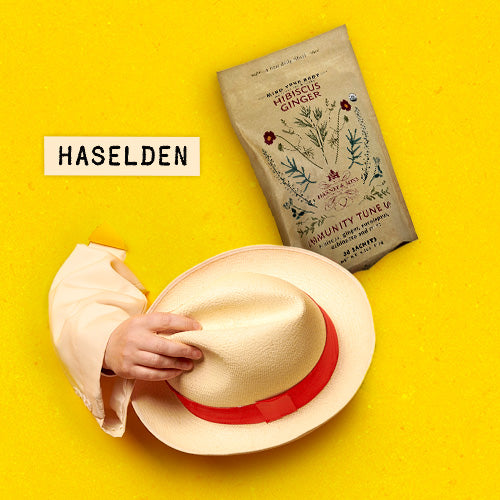 Haselden with Harney & Sons Organic Hibiscus Ginger tea, holding a Panama hat
