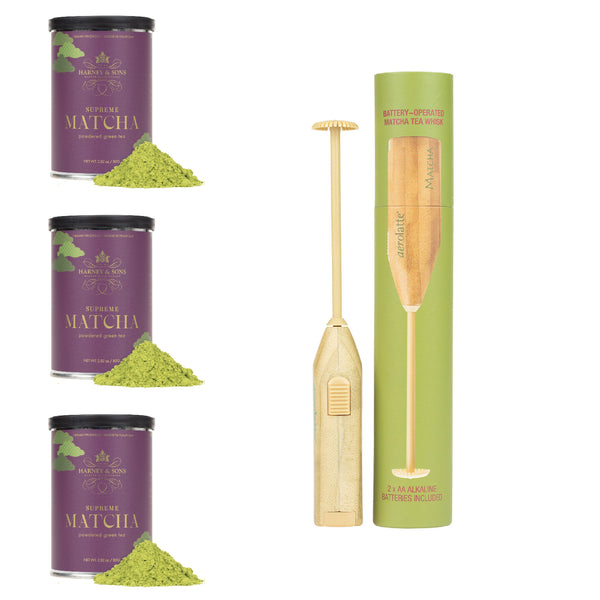 Matcha green tea packaging with three tins and a bamboo whisk on a white background