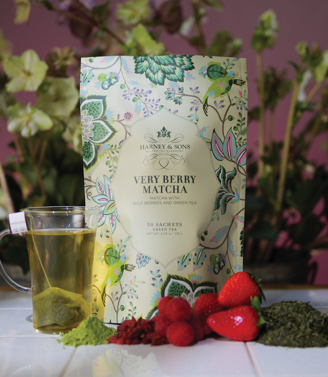Harney & Sons Very Berry Matcha bag with 50 sachets, surrounded by goji berries, strawberries, and green tea.