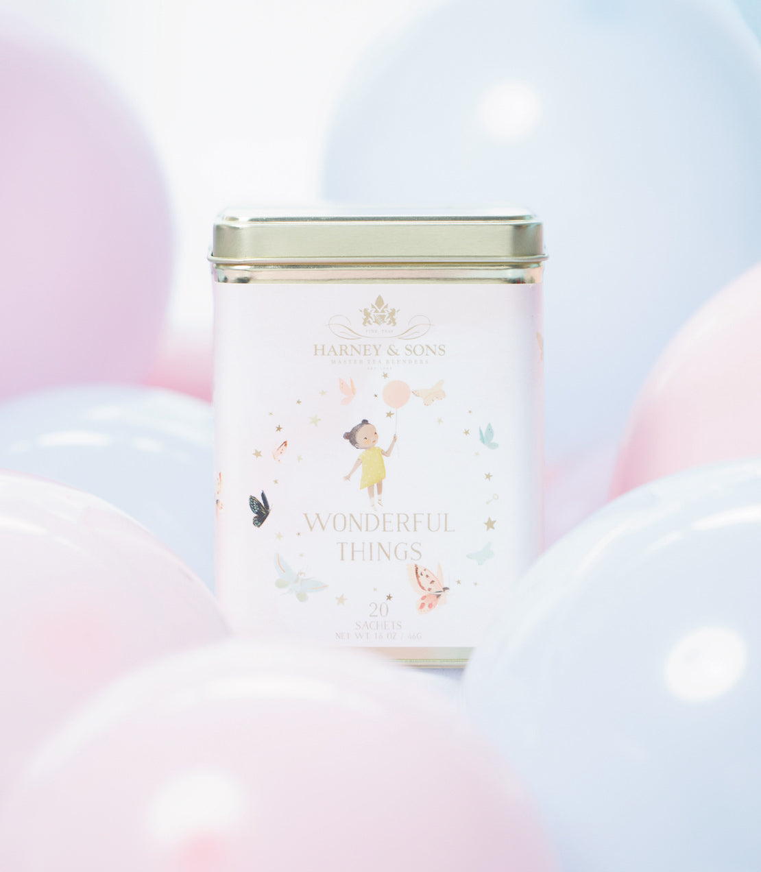 "Harney & Sons Wonderful Things tin featuring a girl, containing 20 sachets, surrounded by pastel balloons.