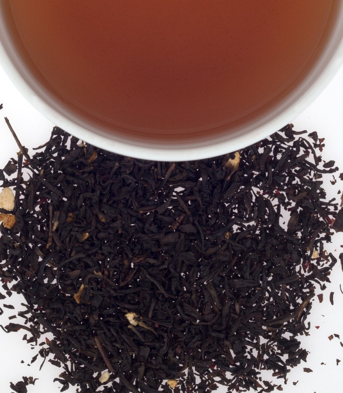 Cranberry Autumn tea sachets in a tin, with brewed tea and loose tea leaves displayed. Perfect for fall flavors.