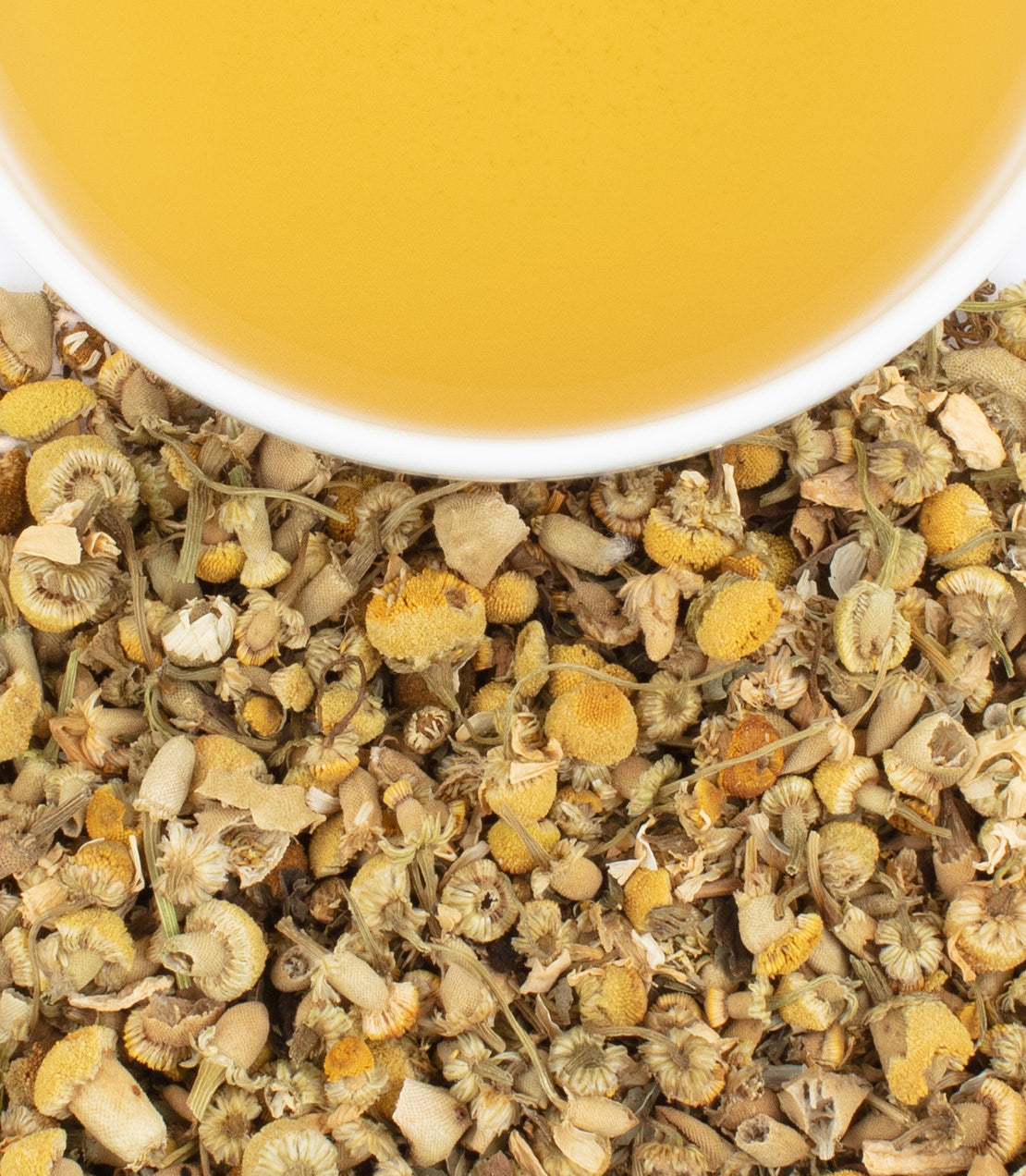 New York Blend tea sachets with a cup of brewed tea above a bed of dried herbs and flowers.