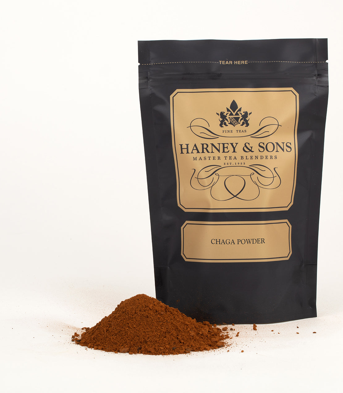 Chaga mushroom powder in a black pouch by Harney & Sons, with a mound of powder beside it.