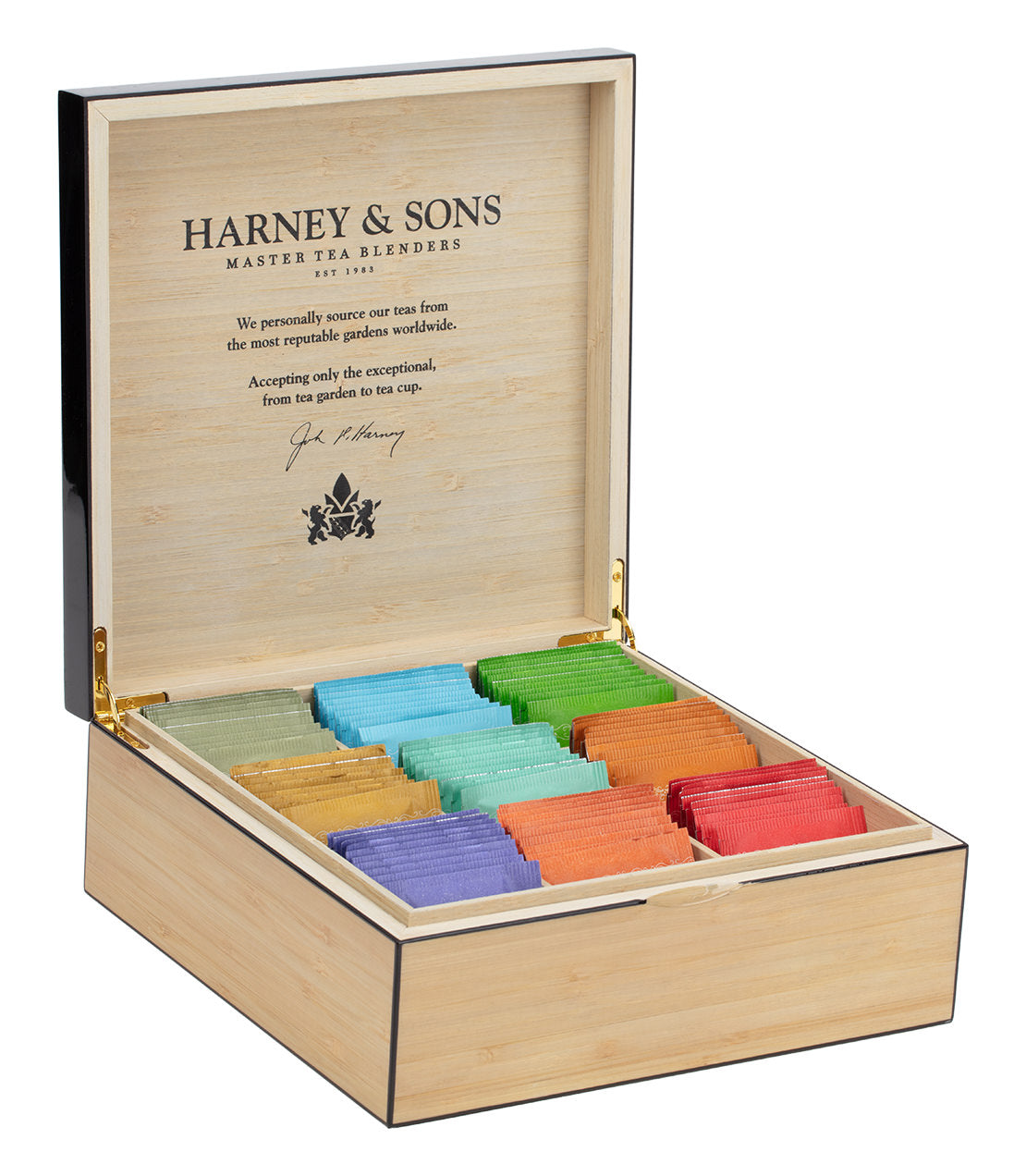 Heirloom tea chest with nine colorful teabags arranged neatly inside a wooden box, showcasing Harney & Sons branding.