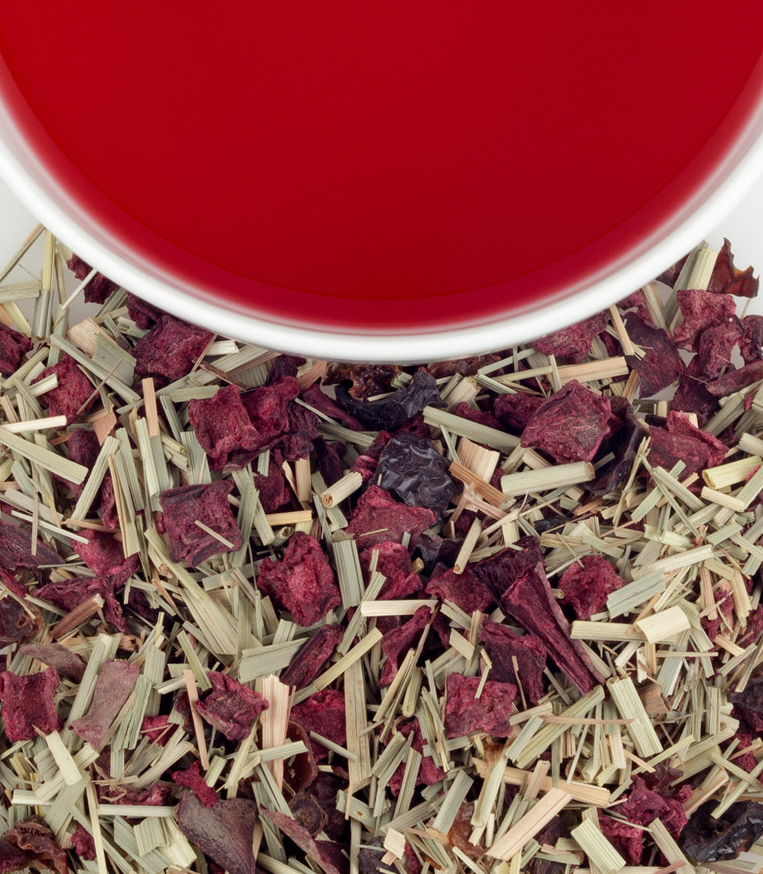 Organic beetroot sachets with dried beetroot and lemongrass, next to a cup of vibrant red beetroot tea.