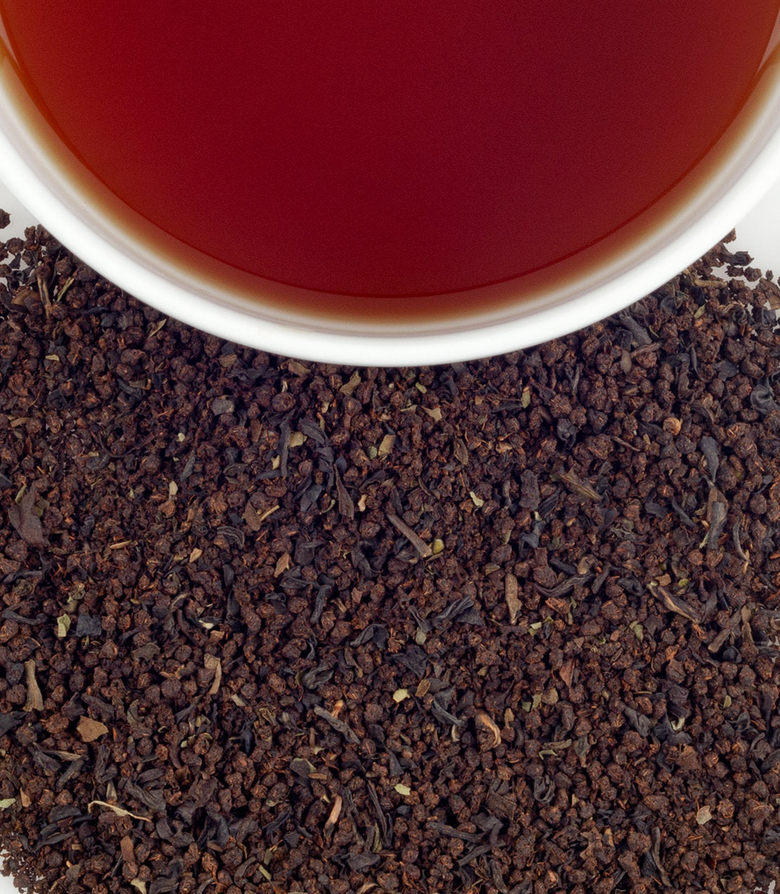 Scottish Afternoon tea sachets, featuring rich black tea leaves and a brewed cup of deep amber tea.